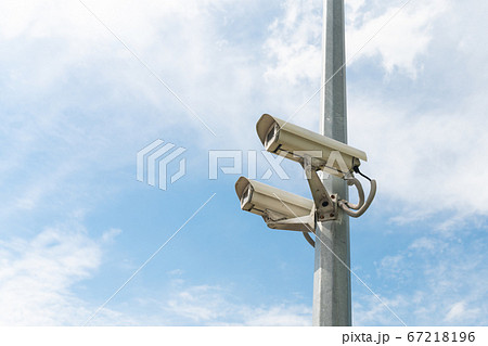Security cameras on a concrete pole 67218196