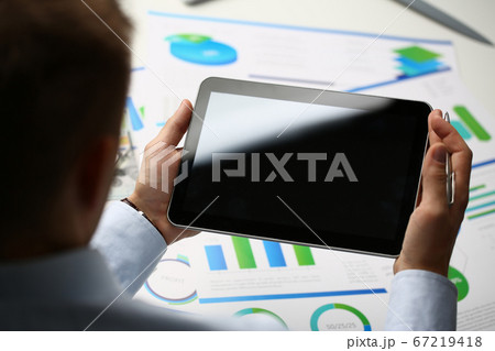 Close up of male hands holding tablet in the office 67219418