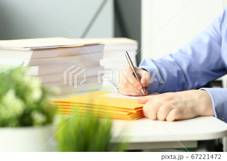 Office employee filling out a form on an envelope 67221472