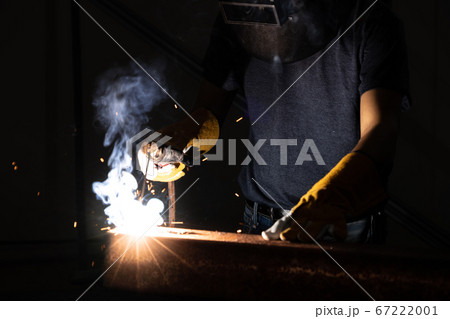 Metal welder working with arc welding machine. 67222001