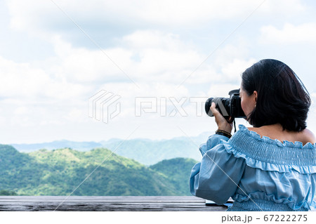 Tourists taking photo of natural scenery 67222275