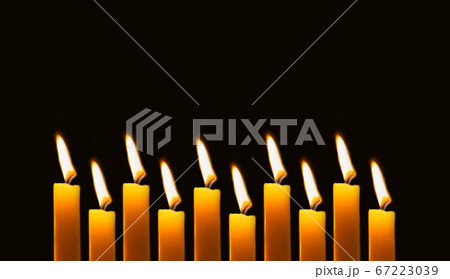 Wax candles burning in darkness. Long banner with 67223039