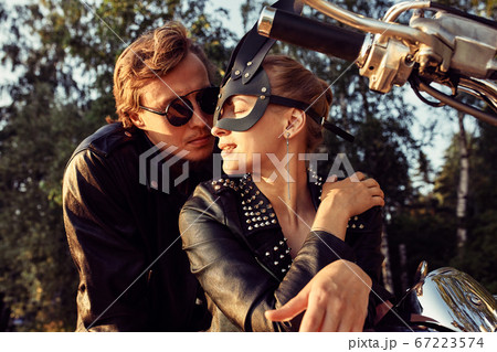 Sexy couple of bikers on the vintage custom motorcycle, girl in a rabbit mask 67223574