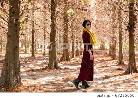 mature woman walk in the forest mature woman walk in the forest 67225050