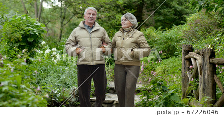 Happy senior woman and man in park Happy senior woman and man in park 67226046