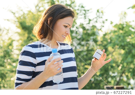 Mature woman with medication bottles of medicine, vitamins, supplements 67227291