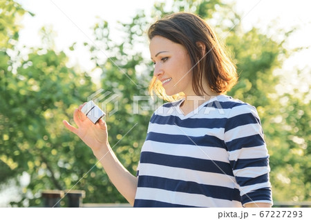 Outdoor middle-aged woman with medicine, vitamins, supplements 67227293