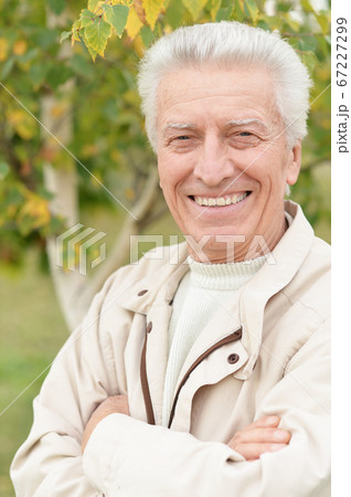 Portrait of happy smiling senior man in park 67227299