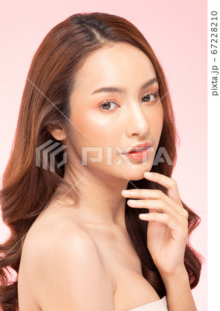 Beautiful Asian woman smile touching chin with clean and fresh skin Happiness and cheerful with positive emotional,isolated on pink background,Beauty Cosmetics and spa Treatment Concept 67228210