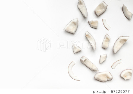 Raw coconut pieces on a white background Raw coconut pieces on a white background 67229077