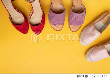 Different shoes on a yellow background with copy space, flat lay. Beauty blog concept. 67229132