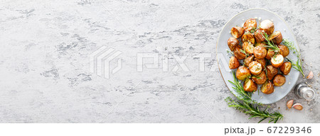 Baked potatoes with rosemary, thyme and garlic. Baked potatoes with rosemary, thyme and garlic. 67229346