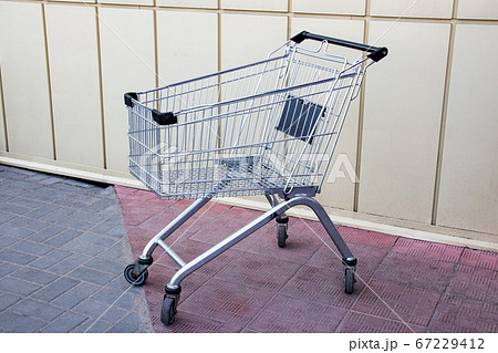 Empty shopping trolley for groceries close up Empty shopping trolley for groceries close up 67229412