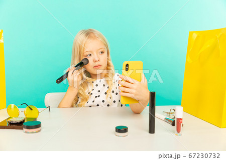 Happy girl at home speaking in front of camera for vlog. Young beauty blogger recording video tutorial for Internet. Happy girl at home speaking in front of camera for vlog. Young beauty blogger recording video tutorial for Internet. 67230732