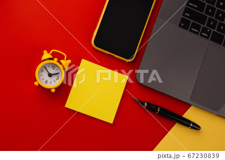 Creative home workplace with black pen, clcok and yellow sticky note, place for text. Work from home concept 67230839