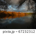 Picturesque lake shore in sunset tones 67232312