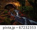 Old stone bridge with mountain stream 67232353