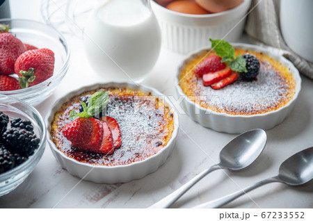 creme brulee with fruits and mint on white 67233552