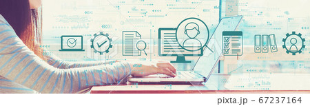 Document management system concept with woman working on a laptop Document management system concept with woman working on a laptop 67237164