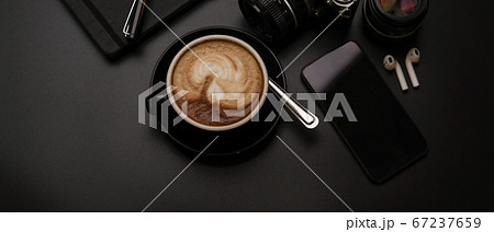 Black cup of coffee on dark office desk with Black cup of coffee on dark office desk with 67237659