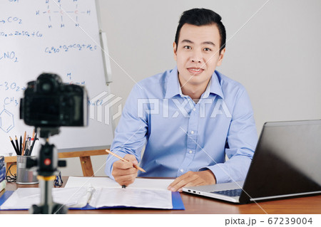 Teacher checking attendance of students 67239004