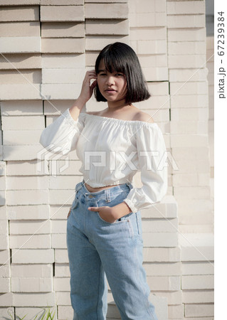 asian teenager sitting on stack of contruction asian teenager sitting on stack of contruction 67239384