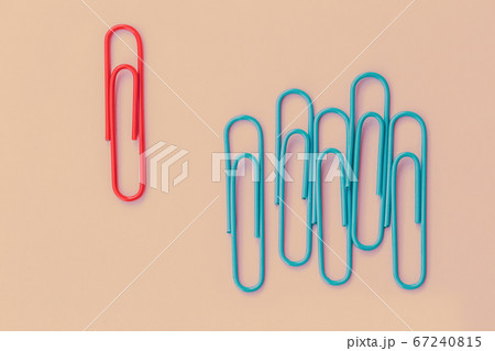 Business minimal concept as a group of paperclip on pink pastel background with one individual in the opposite direction. The idea about the business leadership, think different. Business minimal concept as a group of paperclip on pink pastel background with one individual in the opposite direction. The idea about the business leadership, think different. 67240815