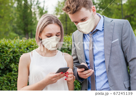 Young woman and man wearing medical mask Young woman and man wearing medical mask 67245139