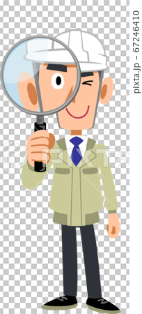 A man in work clothes wearing a helmet looking through a magnifying glass 67246410