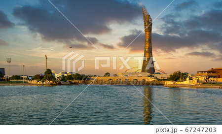 Doha,Qatar-December 7,2019: Aspire park daylight view with fountain and  The Torch Doha Hotel in background 67247203