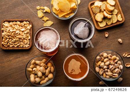Pint of beer for friends. Craft drinks in glasses and snacks on table 67249626