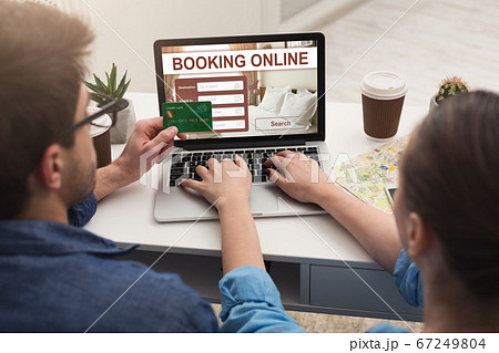 Couple making hotel reservation online, using laptop 67249804