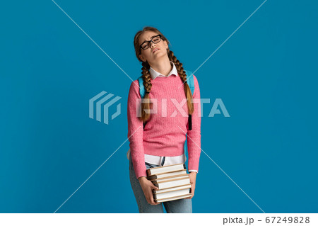 Tired teenager girl with many books, empty space 67249828