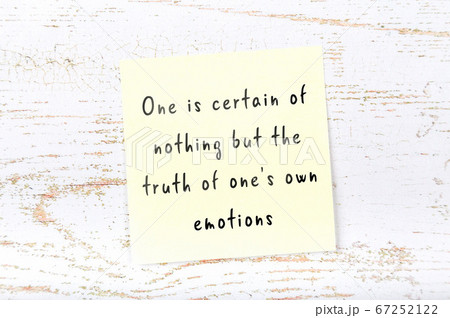 Wise quote on sticky note on wooden wall  67252122