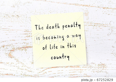 Yellow sticky note on wooden wall with wise quote 67252829