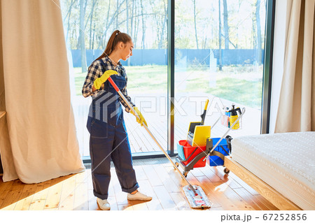 Perfect cleaning by young caucasian woman in uniform 67252856