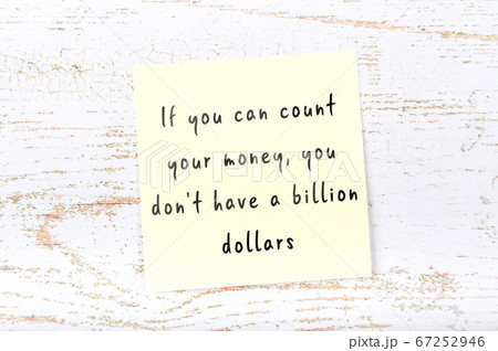 Wise quote on sticky note on wooden wall Wise quote on sticky note on wooden wall 67252946
