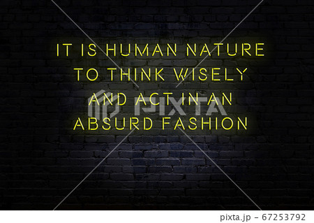 Wise quote. Neon inscription against brick wall 67253792