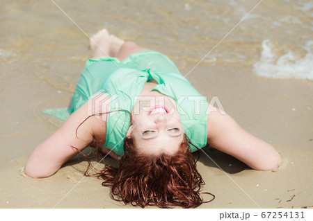Sensual girl wet cloth in water on the coast. 67254131
