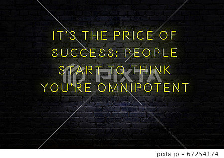Wise quote. Neon inscription against brick wall Wise quote. Neon inscription against brick wall 67254174