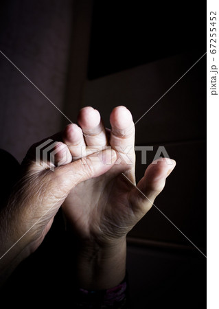 Hands of elderly woman doing a selfmassage Hands of elderly woman doing a selfmassage 67255452