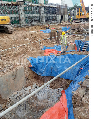 KUALA LUMPUR, MALAYSIA -JUNE 29, 2017: Construction workers spraying the anti termite chemical treatment to the soil at the construction site. KUALA LUMPUR, MALAYSIA -JUNE 29, 2017: Construction workers spraying the anti termite chemical treatment to the soil at the construction site. 67255918