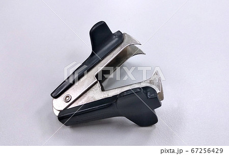 Old staple puller or staple remover isolated on white background.  67256429