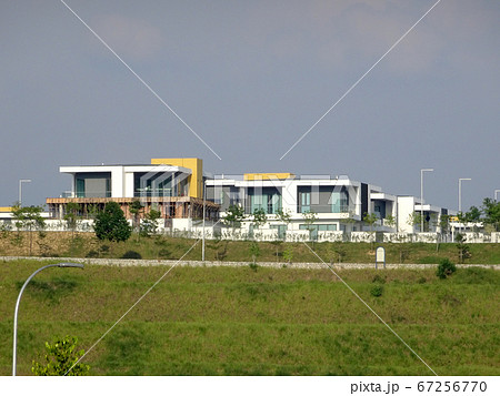 KUALA LUMPUR, MALAYSIA -MAY 26, 2017: Terrace house under construction in Malaysia. Designed by an architect with modern and contemporary style. The wall erected by using bricks. KUALA LUMPUR, MALAYSIA -MAY 26, 2017: Terrace house under construction in Malaysia. Designed by an architect with modern and contemporary style. The wall erected by using bricks. 67256770