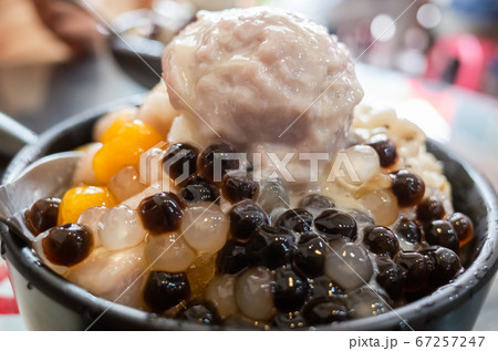 eating shaved ice with colorful dessert 67257247