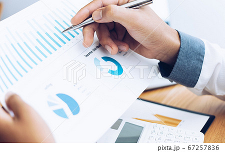 Business men use calculators to calculate the company's tax and revenue in the office, Financial and accounting banking concepts. 67257836