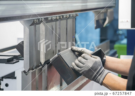 The metalworking operator working with hydraulic bending machine. 67257847