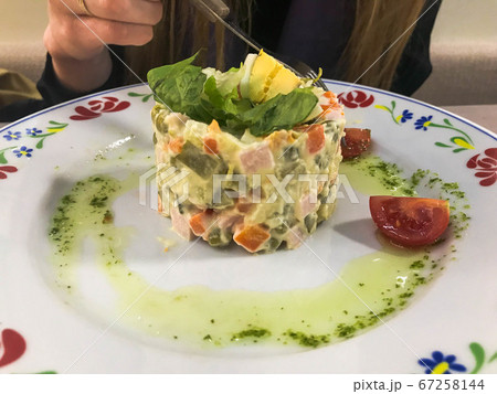 The girl eats Russian national salad "Olivier" 67258144