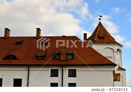 Tall steeples and towers, the roof of an old Tall steeples and towers, the roof of an old 67258542
