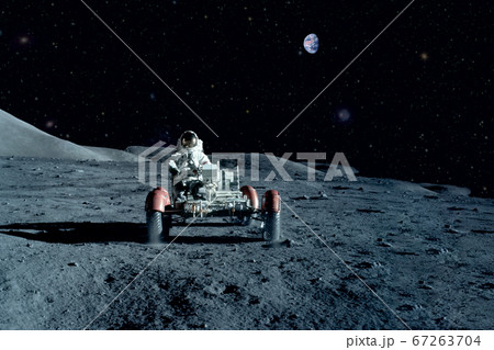 Astronaut near the moon rover on the moon. With 67263704